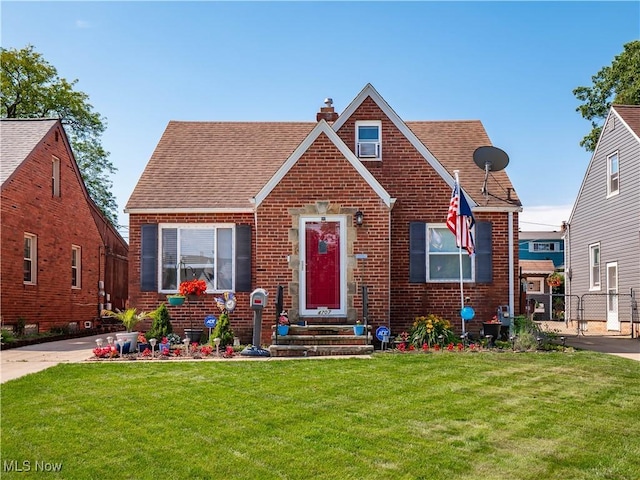 4707 Grantwood Dr, Parma, OH 44134 - english style home with brick siding, a chimney, roof with shingles, and a gate