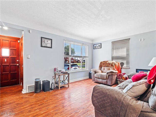 4707 Grantwood Dr, Parma, OH 44134 - living area with wood finished floors and a textured ceiling
