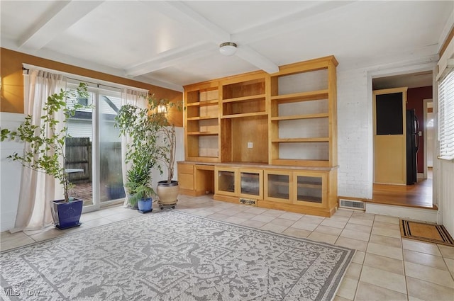 7219 N Lima Rd, Poland, OH 44514 - unfurnished living room with light tile patterned flooring and beam ceiling