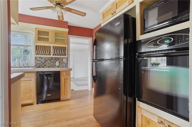 7219 N Lima Rd, Poland, OH 44514 - kitchen with black appliances, tile counters, light wood finished floors, light brown cabinets, and ceiling fan