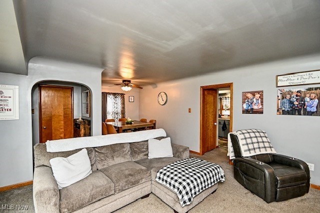 3364 Cormany Rd, Akron, OH 44319 - living area with carpet, a ceiling fan, and arched walkways