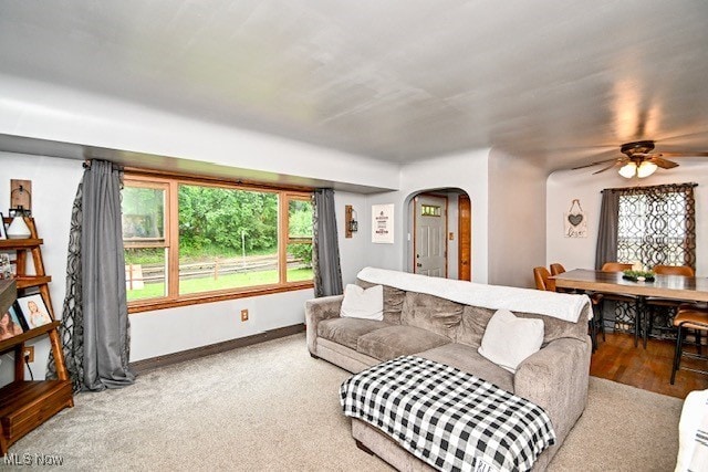 3364 Cormany Rd, Akron, OH 44319 - living area with arched walkways, a ceiling fan, and carpet floors