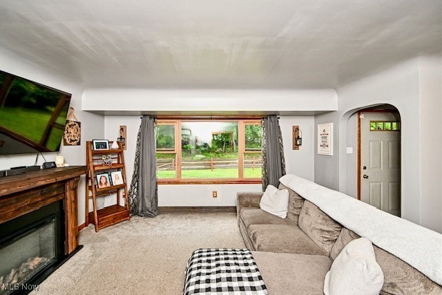 3364 Cormany Rd, Akron, OH 44319 - living room with a glass covered fireplace, carpet flooring, and arched walkways