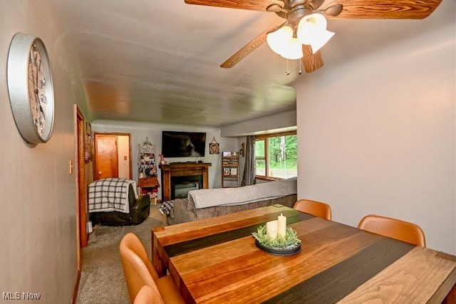 3364 Cormany Rd, Akron, OH 44319 - dining space with a fireplace, carpet flooring, and a ceiling fan