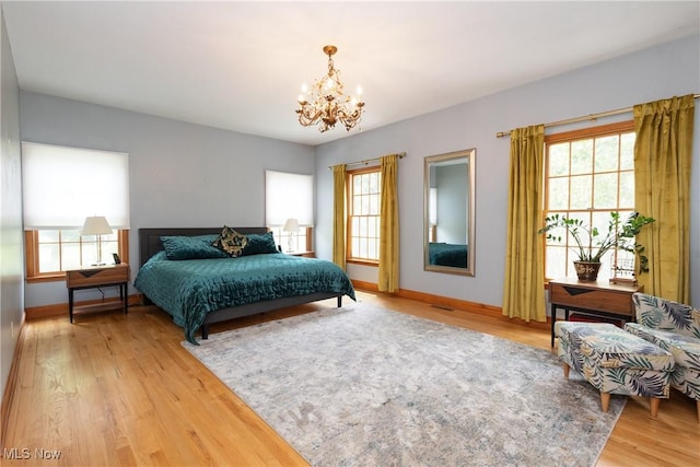 121 Sycamore Pl, Oberlin, OH 44074 - bedroom with a chandelier, multiple windows, and light wood-style floors