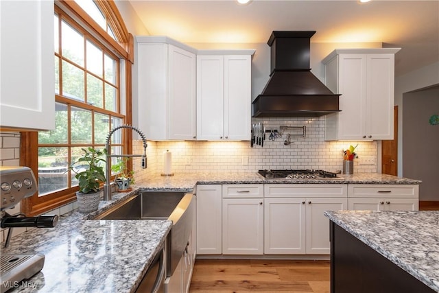 121 Sycamore Pl, Oberlin, OH 44074 - kitchen with wall chimney exhaust hood, white cabinets, and recessed lighting