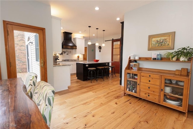 121 Sycamore Pl, Oberlin, OH 44074 - dining area with a barn door, light wood-type flooring, and recessed lighting