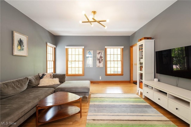 121 Sycamore Pl, Oberlin, OH 44074 - living room featuring healthy amount of natural light, a chandelier, and wood finished floors