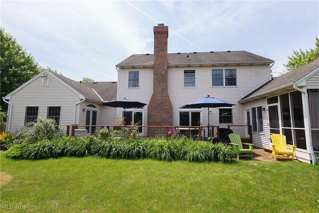 121 Sycamore Pl, Oberlin, OH 44074 - rear view of house with a chimney, a yard, a sunroom, and a wooden deck