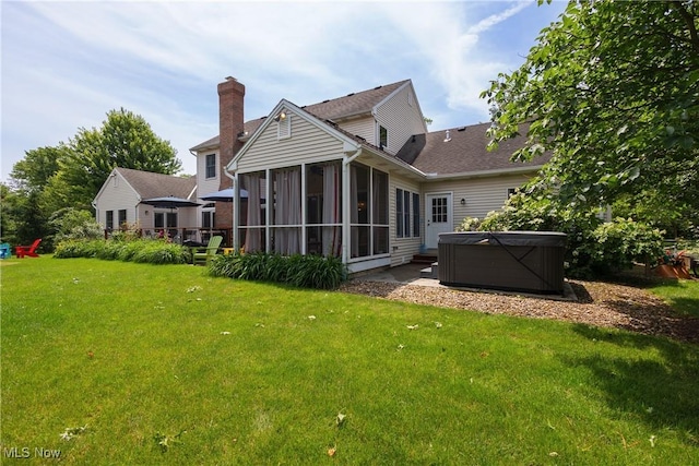 121 Sycamore Pl, Oberlin, OH 44074 - rear view of property with a hot tub, a sunroom, a lawn, and a patio area