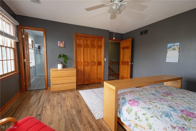 121 Sycamore Pl, Oberlin, OH 44074 - bedroom featuring wood finished floors, a closet, a ceiling fan, and ensuite bath