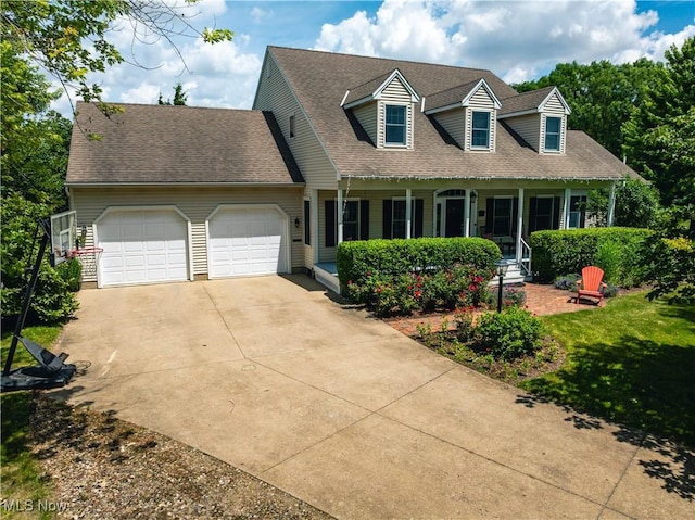 121 Sycamore Pl, Oberlin, OH 44074 - cape cod house with a porch, an attached garage, driveway, roof with shingles, and a front lawn