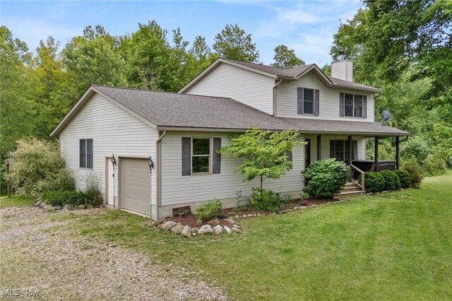 1345 County Road 16, New London, OH 44851 - view of front of home with a chimney, a garage, a front yard, driveway, and covered porch