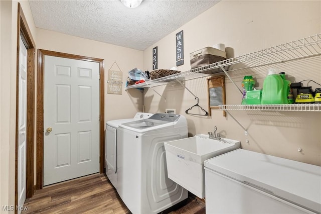 1345 County Road 16, New London, OH 44851 - washroom featuring washer and dryer, wood finished floors, and a textured ceiling