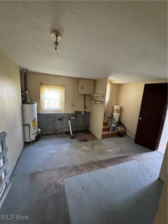 7138 Jefferson Rd, Ashtabula, OH 44004 - kitchen with gas water heater, a textured ceiling, and concrete floors