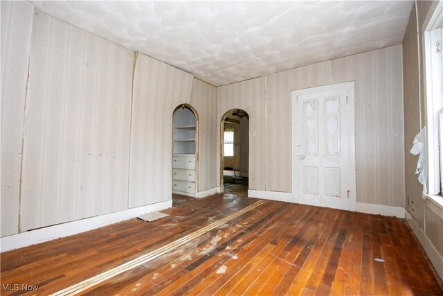 274 E S St, Shreve, OH 44676 - empty room featuring wood-type flooring and arched walkways