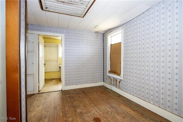 274 E S St, Shreve, OH 44676 - spare room featuring wallpapered walls and dark wood-style floors
