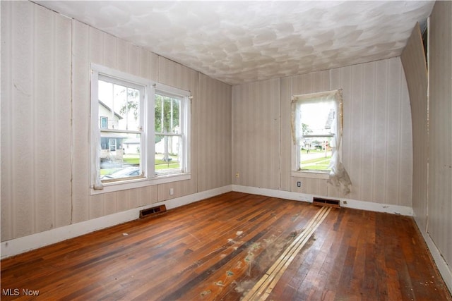 274 E S St, Shreve, OH 44676 - spare room with wood-type flooring, healthy amount of natural light, and a textured ceiling