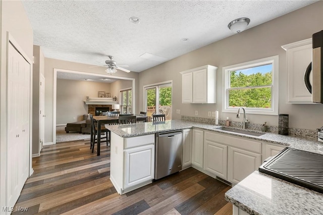 4670 King Meadow Trl, Kent, OH 44240 - kitchen featuring stainless steel dishwasher, ceiling fan, a textured ceiling, dark wood-type flooring, and white cabinets