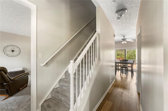 4670 King Meadow Trl, Kent, OH 44240 - stairway featuring a textured ceiling, a ceiling fan, and wood finished floors