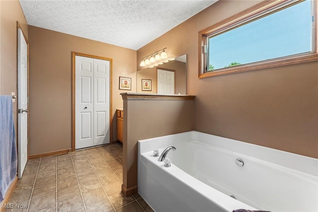 4670 King Meadow Trl, Kent, OH 44240 - bathroom featuring a bath and a textured ceiling