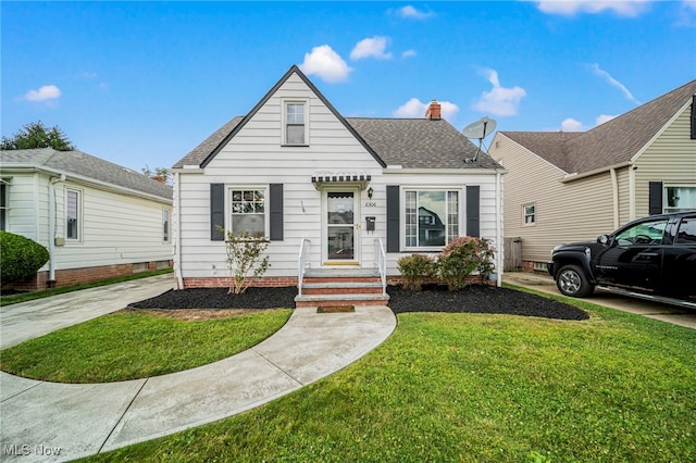 6306 Gilbert Ave, Parma, OH 44129 - view of front of property with a front lawn, a chimney, and roof with shingles