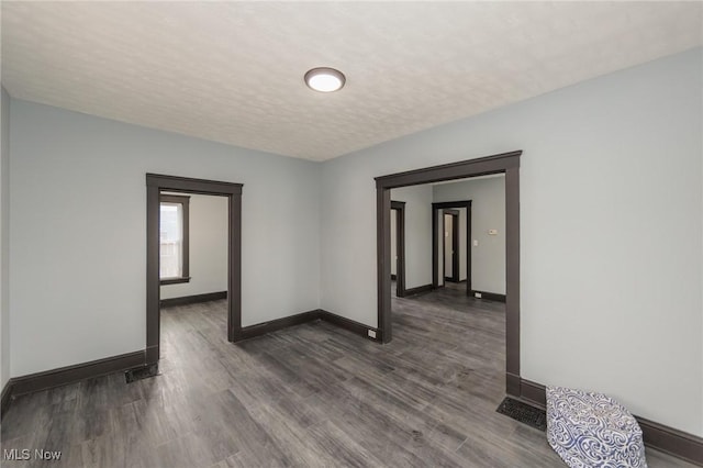1431 Rowley Ave, Cleveland, OH 44109 - empty room featuring dark wood-type flooring and a textured ceiling