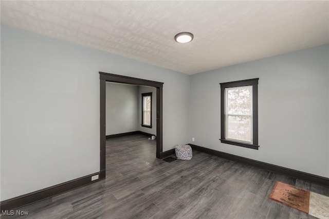 1431 Rowley Ave, Cleveland, OH 44109 - empty room with healthy amount of natural light and dark wood-type flooring