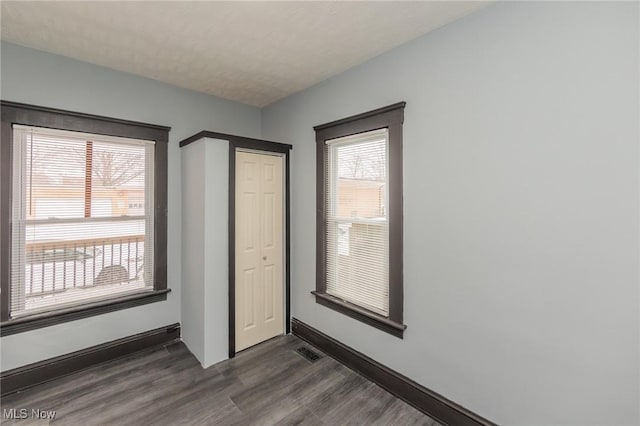 1431 Rowley Ave, Cleveland, OH 44109 - unfurnished bedroom featuring dark wood-type flooring and a closet