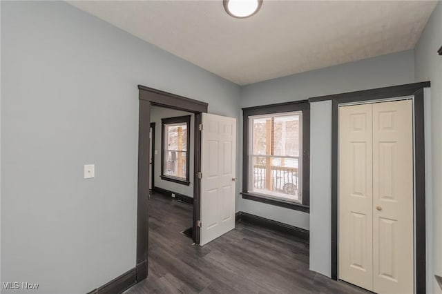 1431 Rowley Ave, Cleveland, OH 44109 - unfurnished bedroom with dark wood-style flooring and a closet