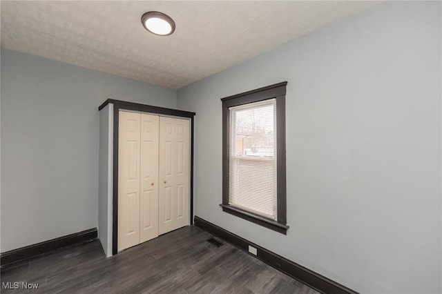 1431 Rowley Ave, Cleveland, OH 44109 - unfurnished bedroom with dark wood-style flooring and a closet