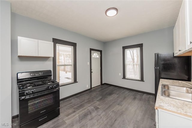 1431 Rowley Ave, Cleveland, OH 44109 - kitchen featuring black range with gas cooktop, light countertops, white cabinetry, and dark wood-style floors