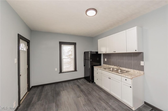 1431 Rowley Ave, Cleveland, OH 44109 - kitchen featuring freestanding refrigerator, white cabinetry, and dark wood-style flooring