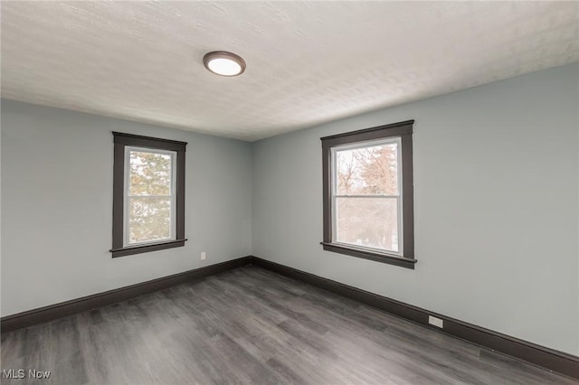 1431 Rowley Ave, Cleveland, OH 44109 - spare room featuring dark wood-style flooring and baseboards