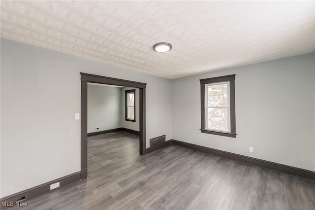 1431 Rowley Ave, Cleveland, OH 44109 - empty room with healthy amount of natural light and wood finished floors
