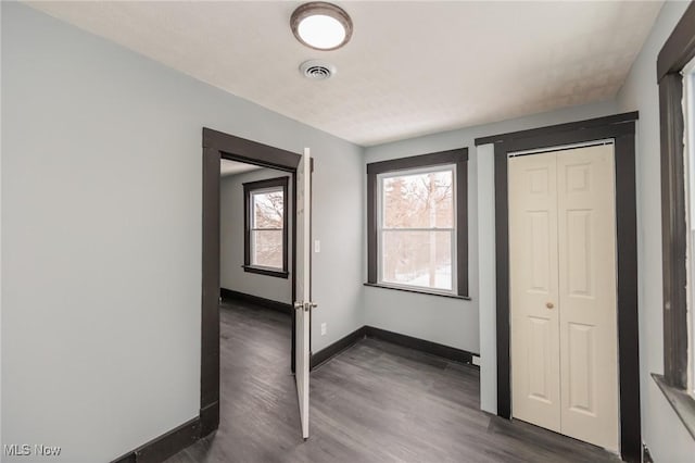 1431 Rowley Ave, Cleveland, OH 44109 - unfurnished bedroom with dark wood-style floors and a closet