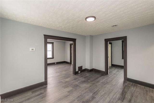 1431 Rowley Ave, Cleveland, OH 44109 - spare room featuring dark wood finished floors and a textured ceiling