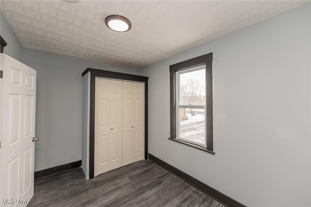 1431 Rowley Ave, Cleveland, OH 44109 - unfurnished bedroom with dark wood finished floors and a closet