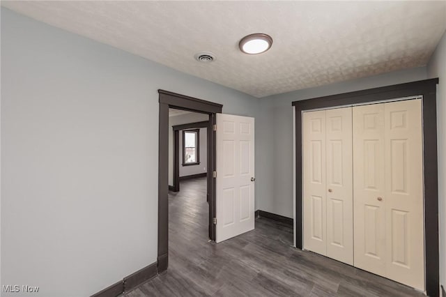1431 Rowley Ave, Cleveland, OH 44109 - unfurnished bedroom featuring dark wood finished floors and a closet