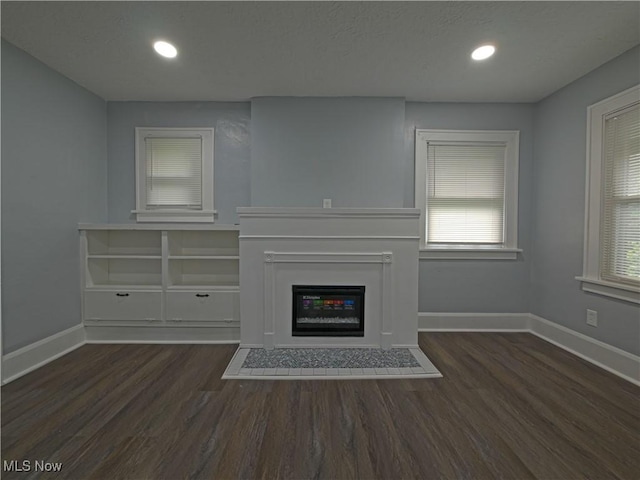 1033 Chalker St, Akron, OH 44310 - unfurnished living room featuring wood finished floors, a glass covered fireplace, and recessed lighting