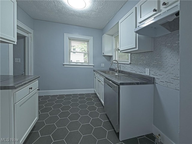 1033 Chalker St, Akron, OH 44310 - kitchen featuring dark countertops, dishwasher, white cabinetry, extractor fan, and dark tile patterned floors