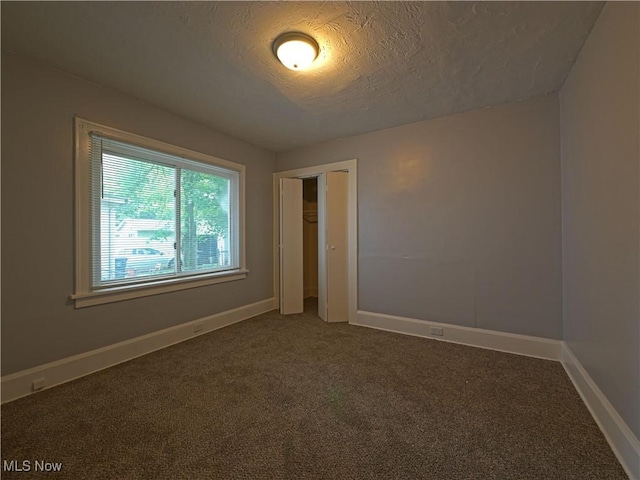 1033 Chalker St, Akron, OH 44310 - carpeted spare room with a textured ceiling and baseboards