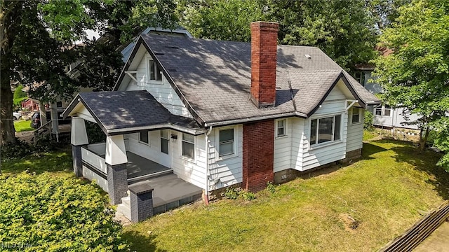 1033 Chalker St, Akron, OH 44310 - back of property with a chimney, a lawn, and roof with shingles