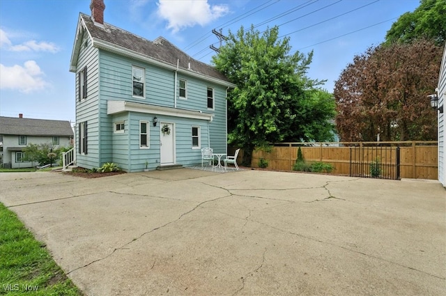 201 E Spring St, Marietta, OH 45750 - rear view of property with a chimney and a patio area