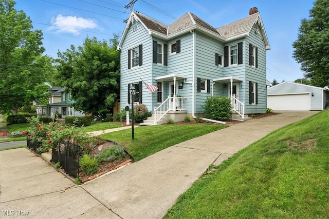 201 E Spring St, Marietta, OH 45750 - view of front of house featuring an outdoor structure, a chimney, a front yard, and a garage