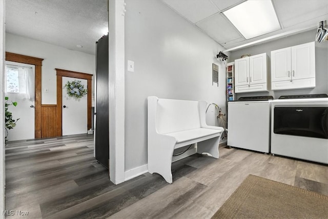201 E Spring St, Marietta, OH 45750 - washroom featuring cabinet space, independent washer and dryer, light wood finished floors, and wainscoting