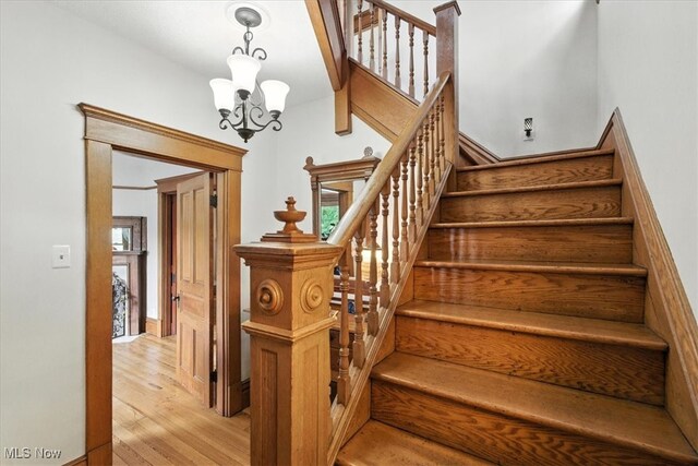 201 E Spring St, Marietta, OH 45750 - stairway featuring wood finished floors and a chandelier