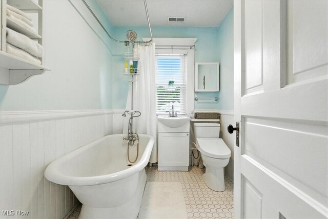 201 E Spring St, Marietta, OH 45750 - full bath with a freestanding bath, wainscoting, and a shower with shower curtain