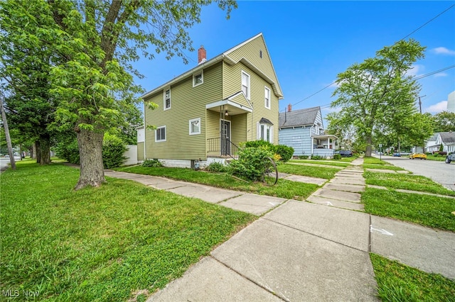 1833 W 7th St, Ashtabula, OH 44004 - traditional home featuring a chimney and a front lawn