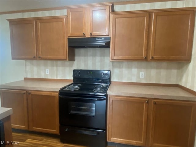 67330 Ebbert Rd Unit 9, Saint Clairsville, OH 43950 - kitchen featuring under cabinet range hood, black electric range oven, light countertops, and dark wood-style floors